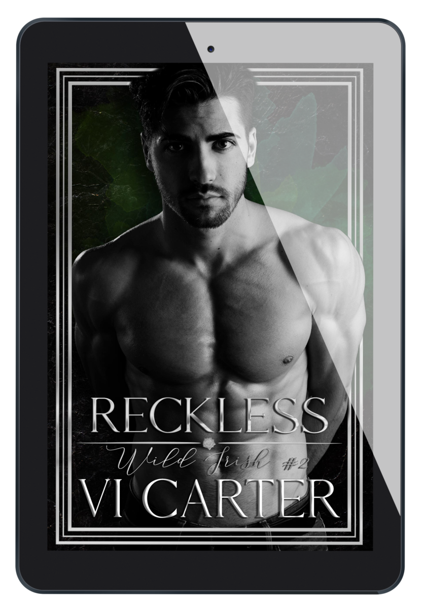 This image features the cover of the book titled "Reckless #2" by Vi Carter. The cover displays a striking black and white photograph of a male figure with a intense gaze, set against a dark background.