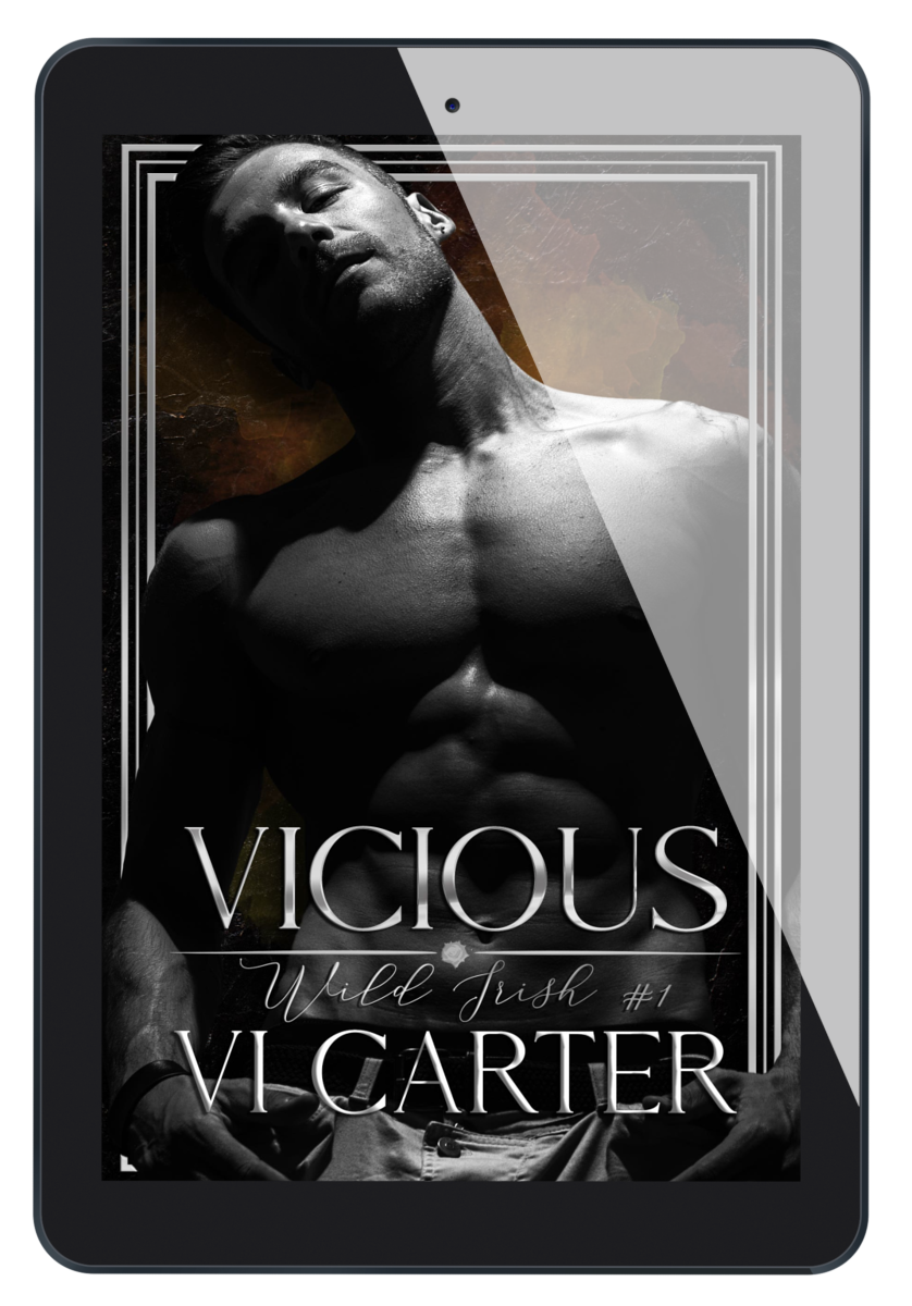 This image features the cover of the book "Vicious #1" by Vi Carter, displayed on a tablet. The book cover is striking with its dark, moody aesthetic and prominently features a male figure with a intense gaze, adding to the novel's dramatic feel.