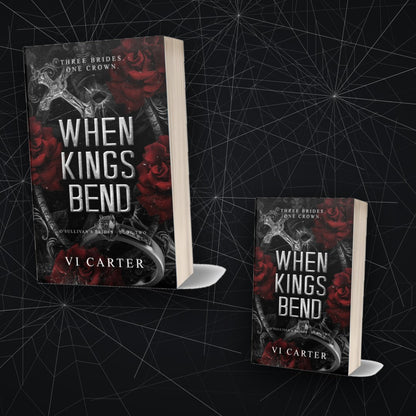 When Kings Bend by Vi Carter — two paperback copies against cracked glass